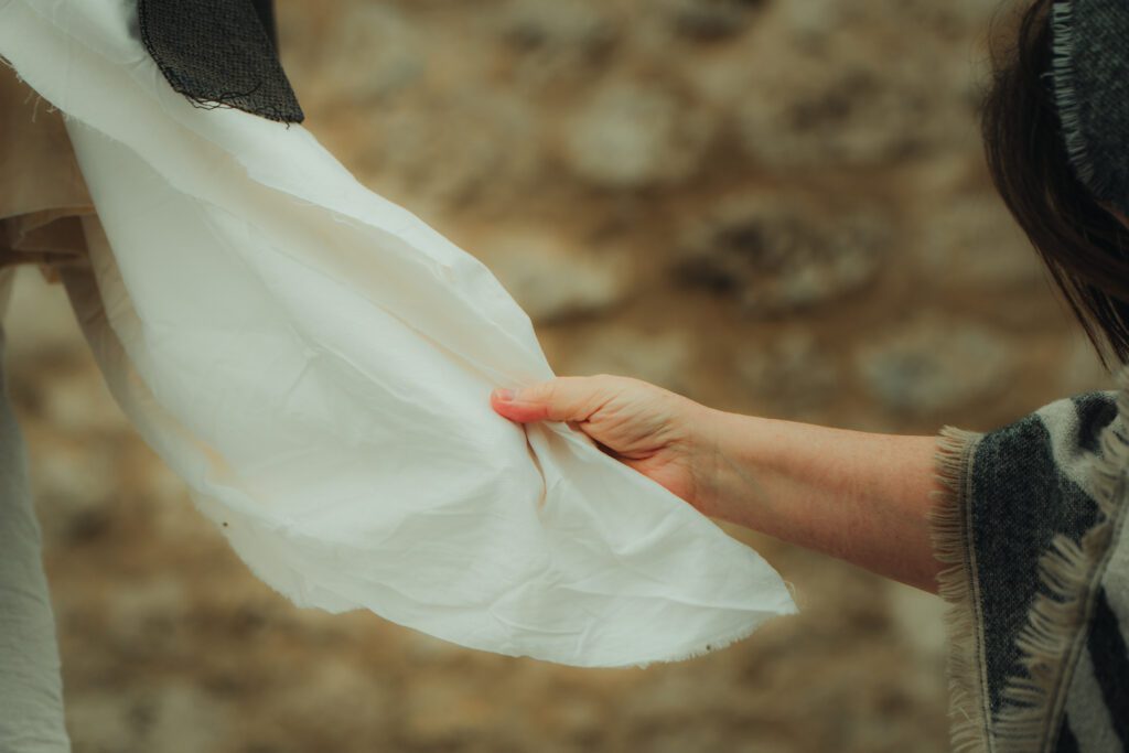 the woman with the issue of bleeding holding Jesus' garment with faith, deepen your faith in difficult times
