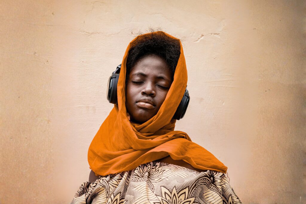 veiled black catholic with headphones, listening to worship music, catholuc new year's resolution