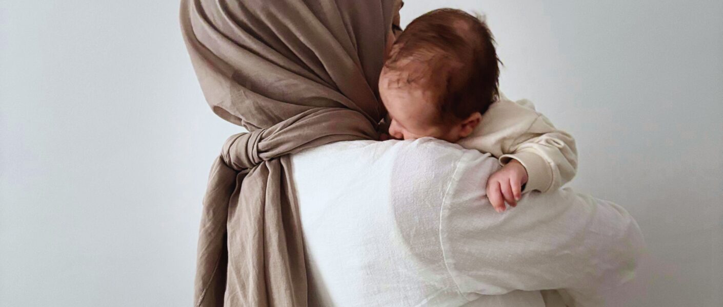 Hijabi woman carrying baby, mother mary carrying Jesus, Mary is our mother, veiled woman holding her baby,