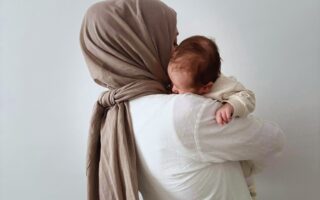 Hijabi woman carrying baby, mother mary carrying Jesus, Mary is our mother, veiled woman holding her baby,