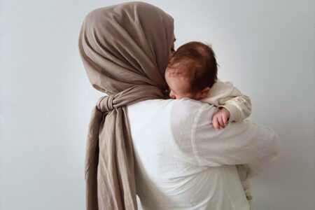 Hijabi woman carrying baby, mother mary carrying Jesus, Mary is our mother, veiled woman holding her baby,
